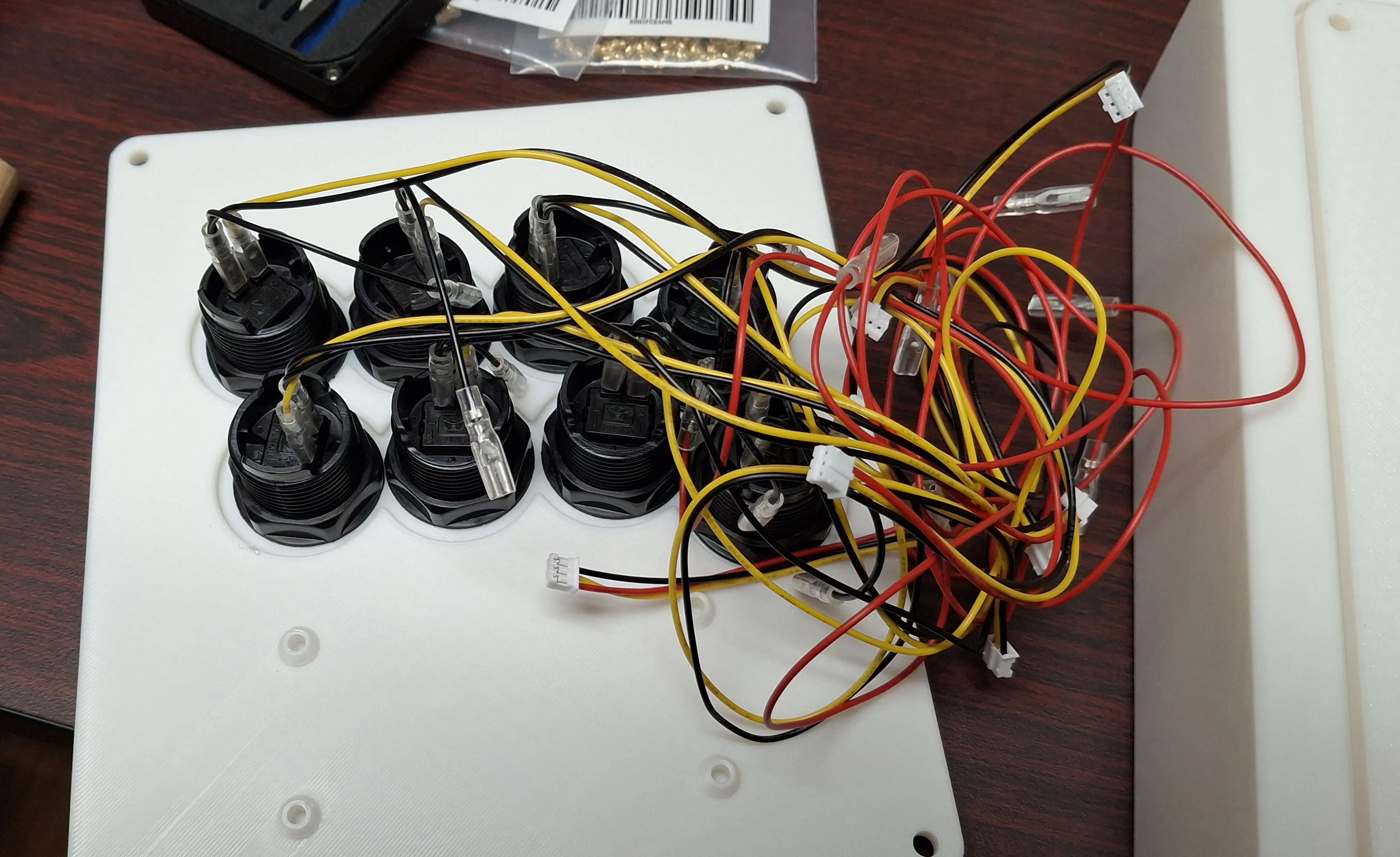 a panel of arcade buttons and their wires