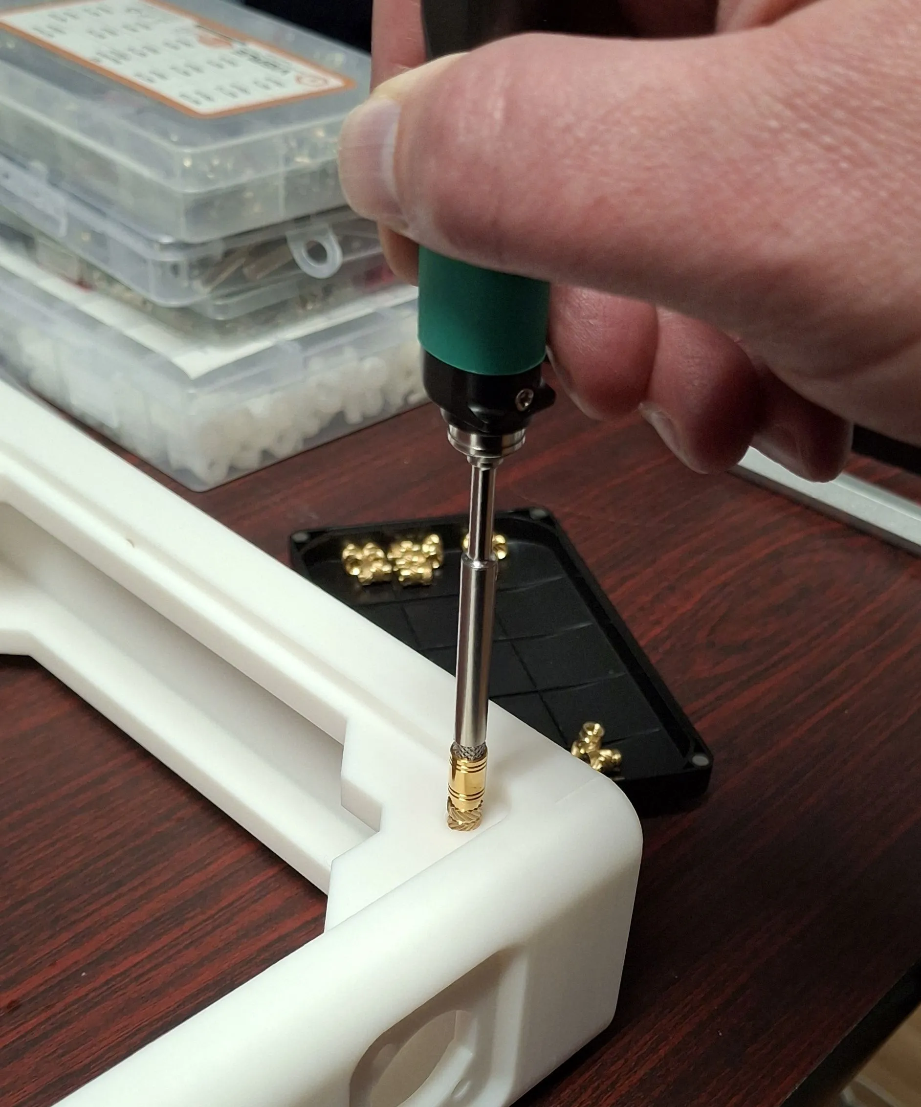 inserting a heat-set insert into a screw hole