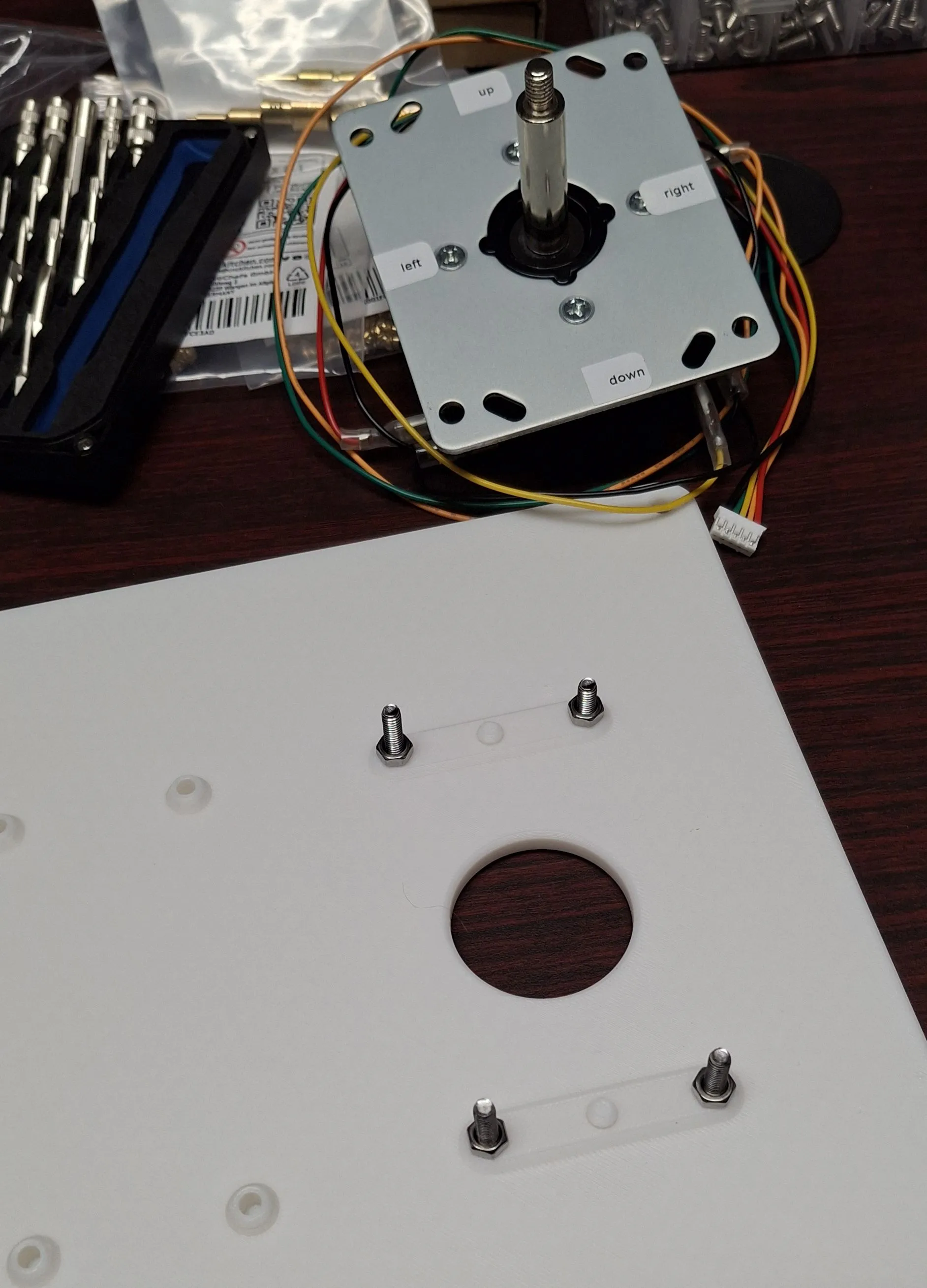 a panel for a joystick with the bolts installed