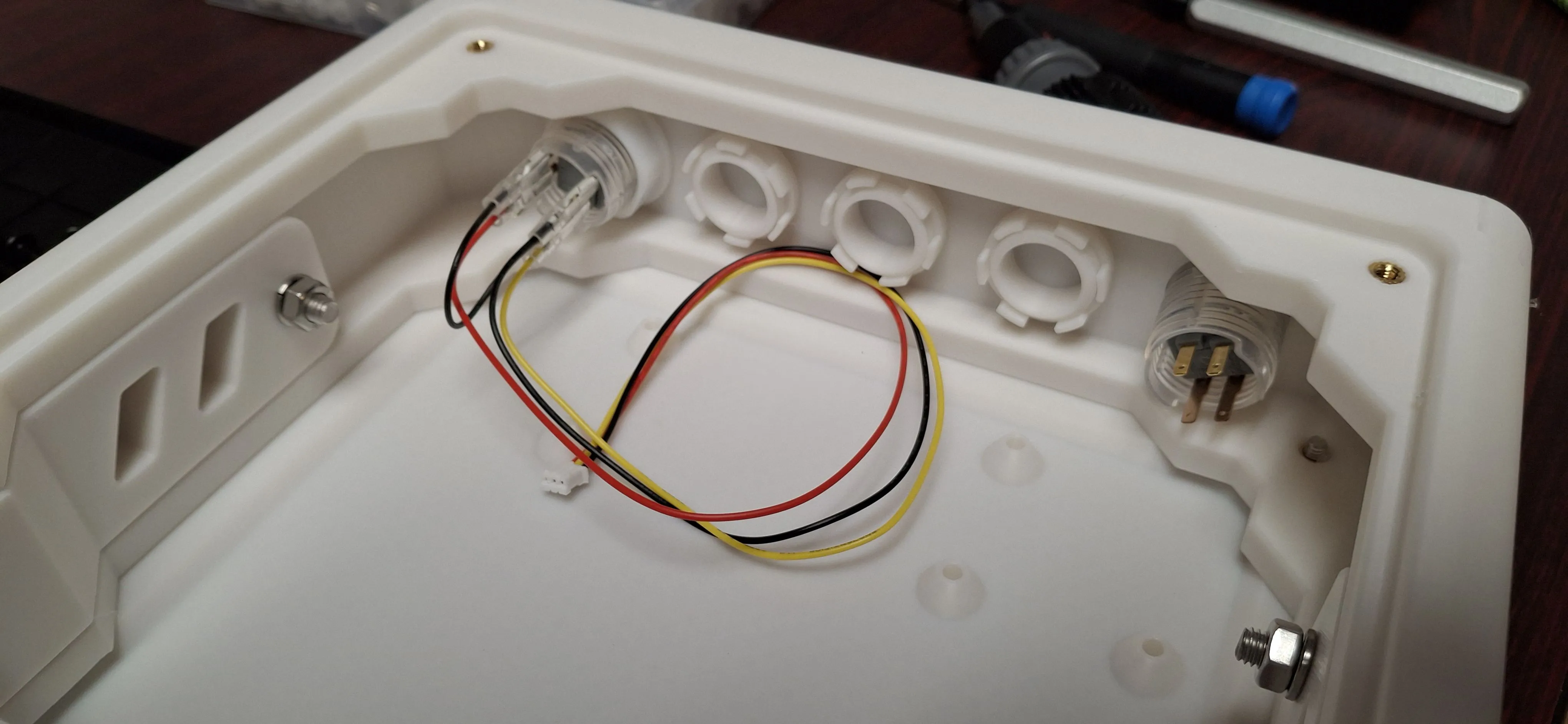 side panel with three plugged openings and two 24mm buttons, one wired